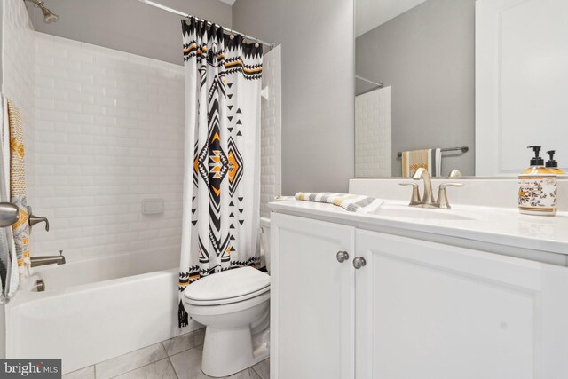 bathroom with tile patterned floors, vanity, toilet, and shower / tub combo with curtain