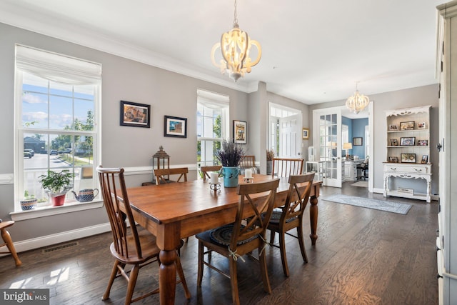 dining space with dark wood finished floors, visible vents, baseboards, and an inviting chandelier