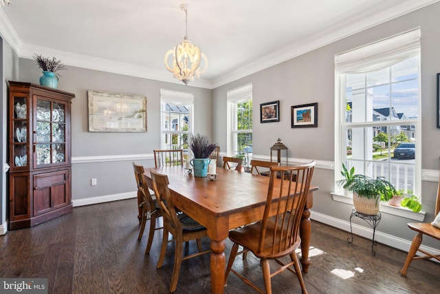 dining room with an inviting chandelier, crown molding, and dark wood-style flooring