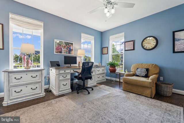 office area with dark wood-type flooring, baseboards, and ceiling fan