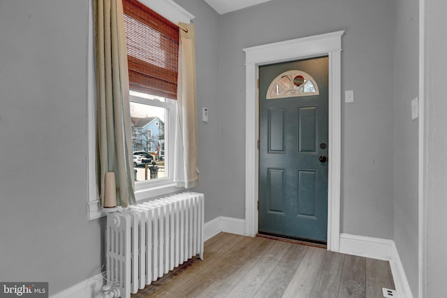 entrance foyer featuring radiator and light hardwood / wood-style floors