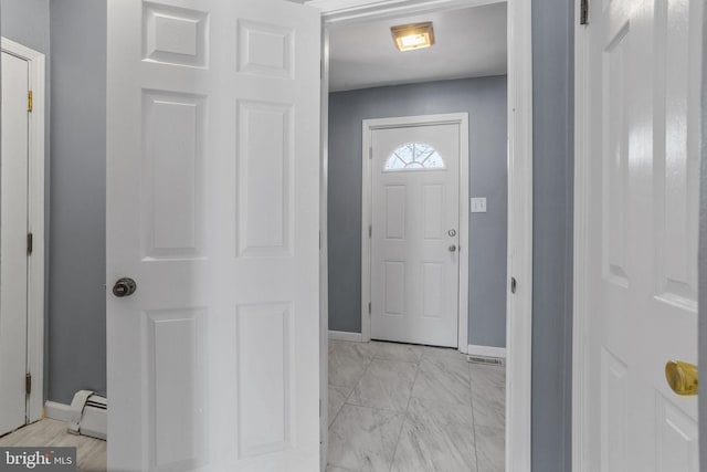 entrance foyer featuring a baseboard heating unit, baseboards, and marble finish floor