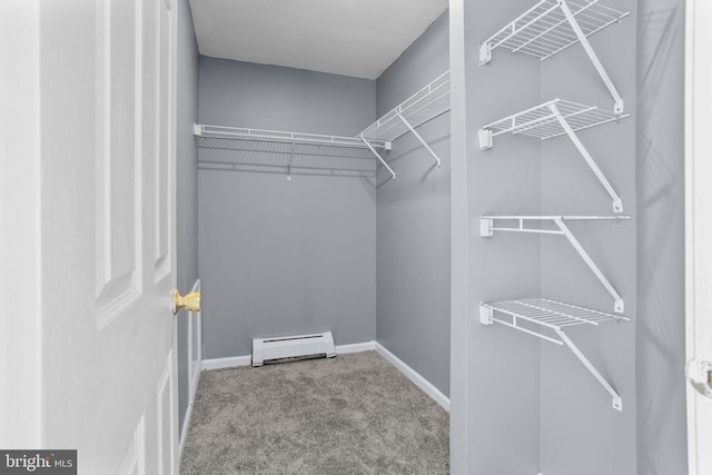 spacious closet with carpet flooring and baseboard heating