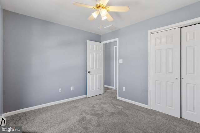 unfurnished bedroom featuring a ceiling fan, visible vents, carpet, baseboards, and a closet