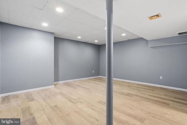 finished below grade area featuring visible vents, recessed lighting, baseboards, and wood finished floors