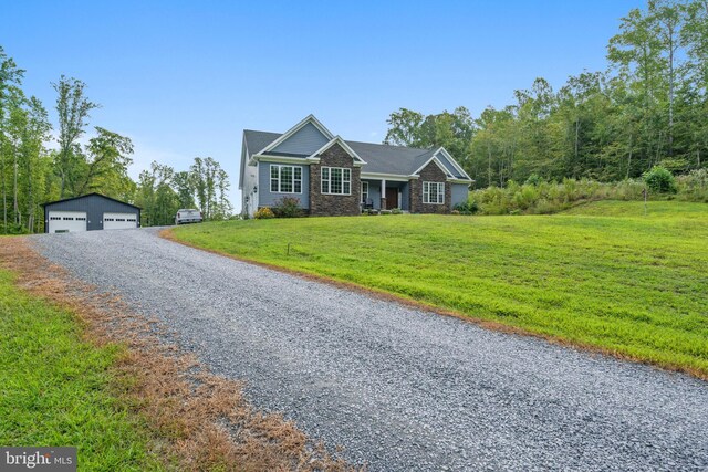 view of front of property with a front yard, an outbuilding, and a garage