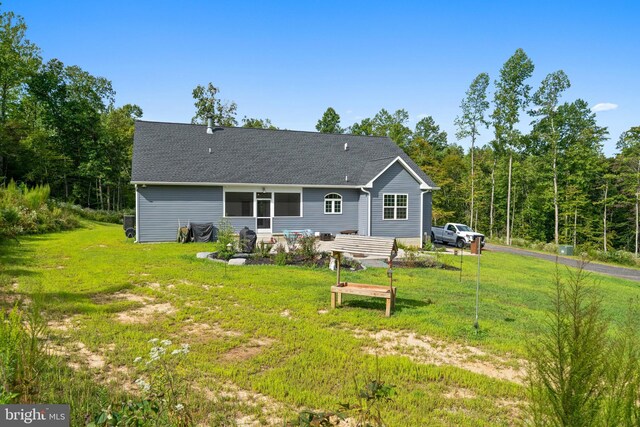 rear view of property with a lawn