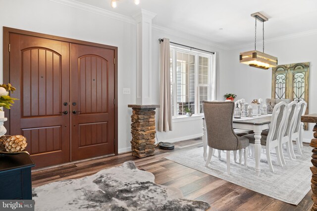 interior space with ornamental molding, dark hardwood / wood-style floors, and ornate columns