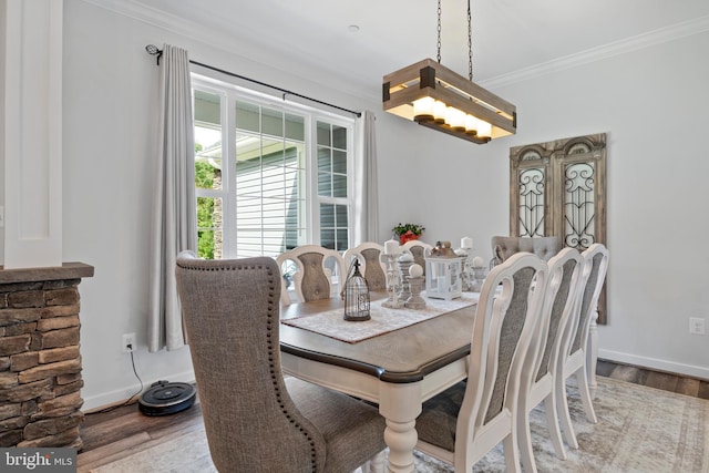 dining space featuring crown molding and hardwood / wood-style floors