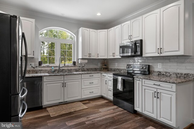 kitchen featuring appliances with stainless steel finishes, dark hardwood / wood-style floors, stone countertops, and white cabinets