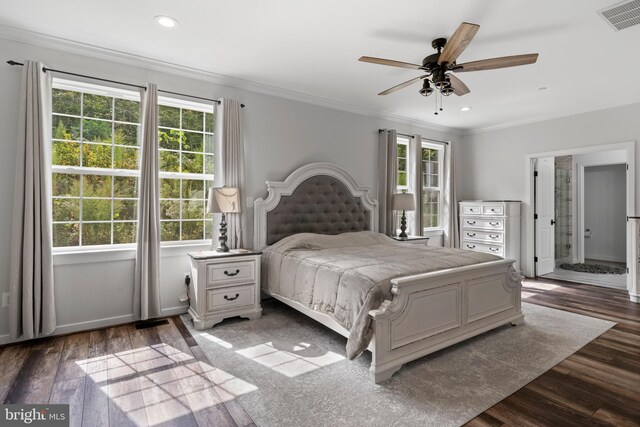 bedroom featuring crown molding, dark wood-type flooring, and ceiling fan