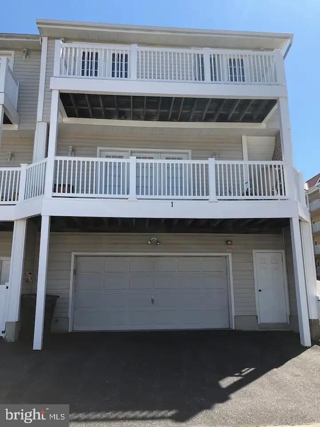 exterior space featuring a balcony and a garage