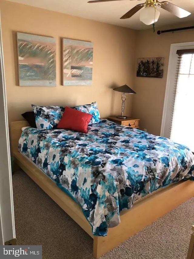 carpeted bedroom featuring ceiling fan