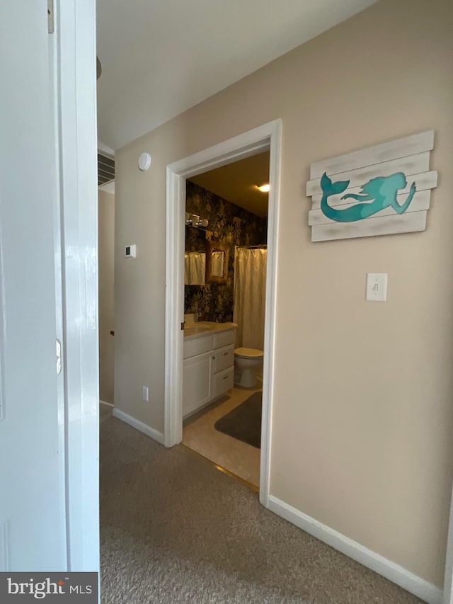 hallway with carpet floors