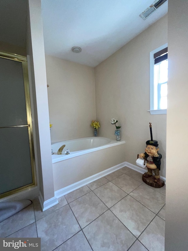 bathroom featuring tile patterned flooring and shower with separate bathtub