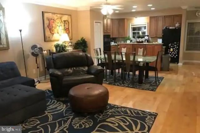 interior space featuring crown molding, ceiling fan, and light hardwood / wood-style floors