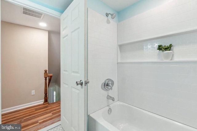 bathroom featuring hardwood / wood-style floors and tiled shower / bath