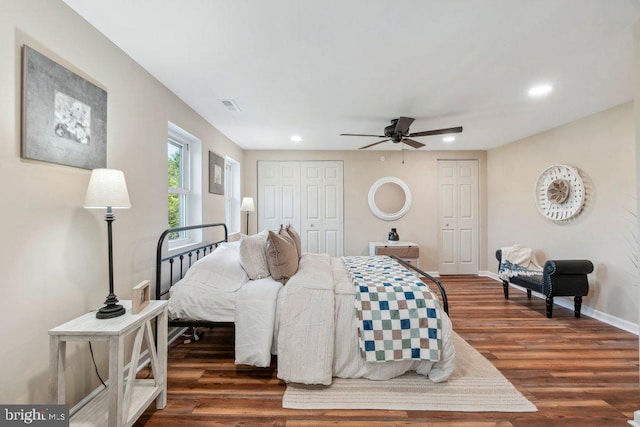 bedroom with dark hardwood / wood-style flooring and ceiling fan