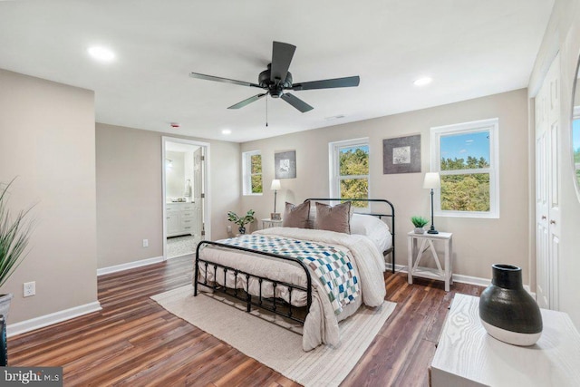 bedroom with a closet, ceiling fan, ensuite bathroom, and dark hardwood / wood-style flooring