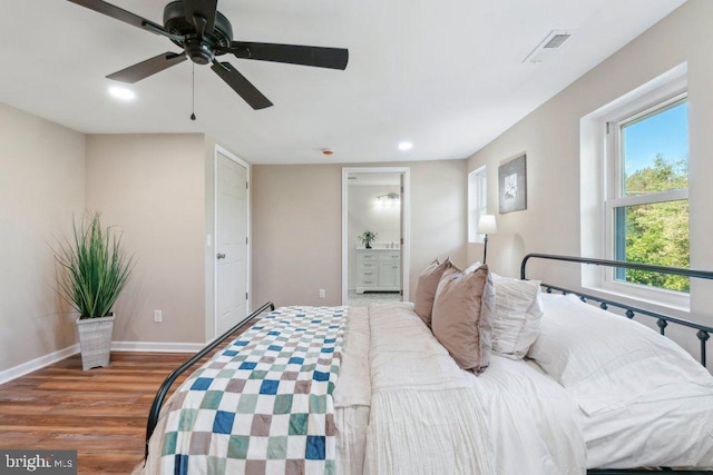 bedroom featuring ceiling fan, ensuite bathroom, and hardwood / wood-style flooring