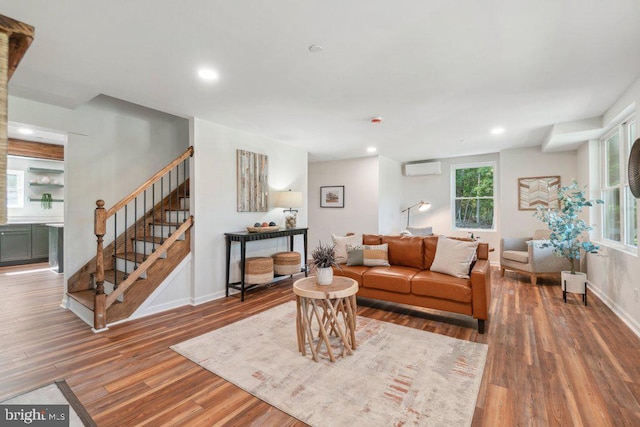 living room with wood-type flooring and a wall unit AC