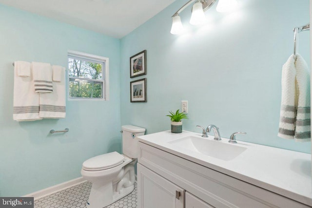 bathroom with vanity, toilet, and tile patterned floors