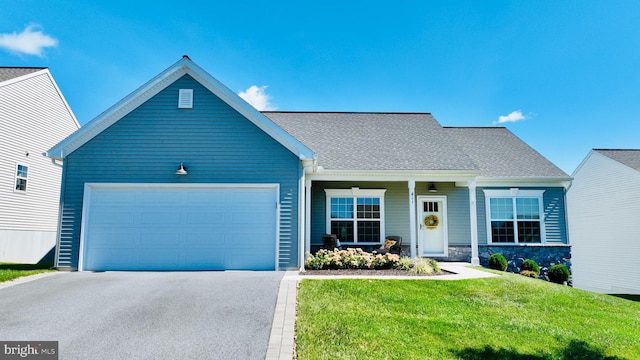 view of front of property with a garage and a front yard