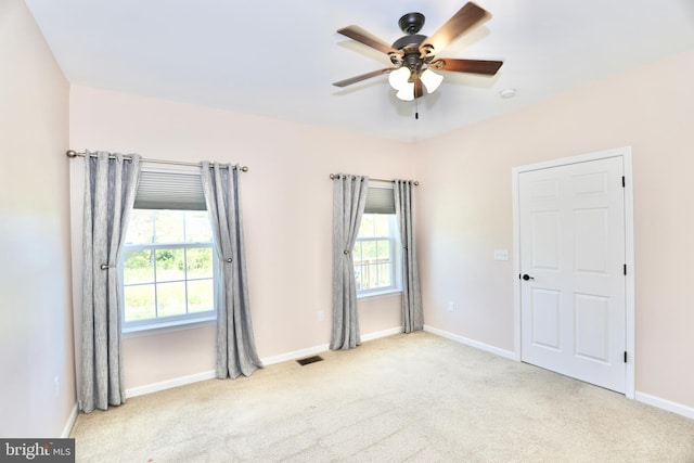 carpeted empty room with ceiling fan