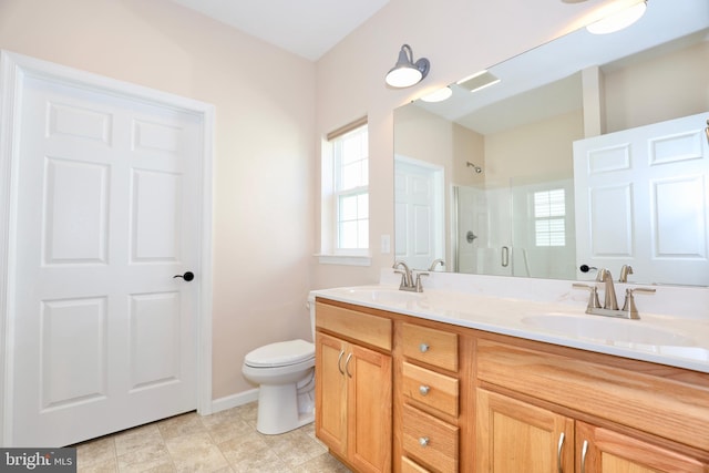 bathroom with tile patterned flooring, vanity, toilet, and walk in shower