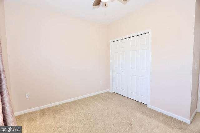 unfurnished bedroom featuring a closet, ceiling fan, and carpet floors