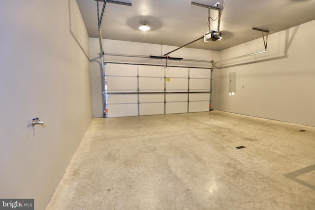 garage with a garage door opener and electric panel