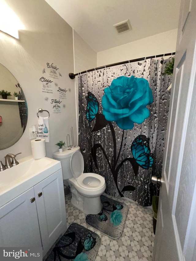 bathroom with vanity, toilet, and walk in shower