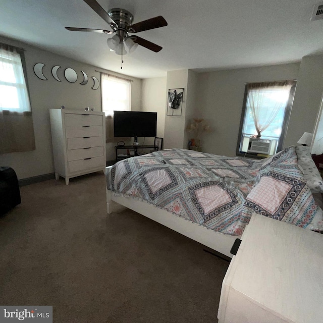 carpeted bedroom with cooling unit, visible vents, and ceiling fan