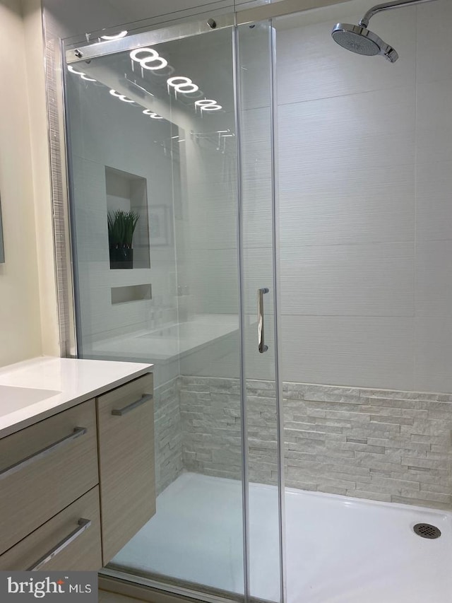 bathroom with vanity and a stall shower
