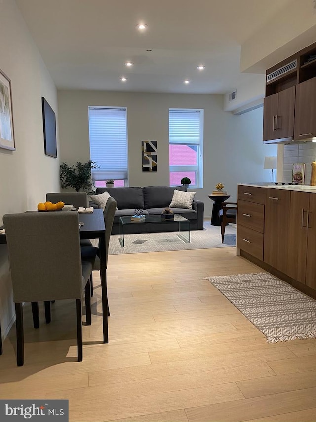 dining area featuring recessed lighting, light wood-style flooring, and visible vents