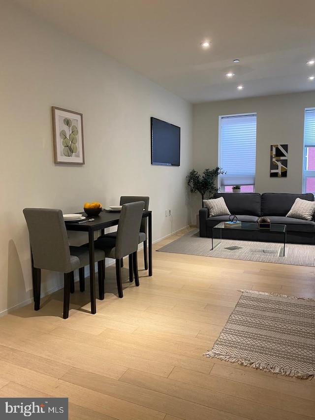 interior space with baseboards, recessed lighting, and light wood-style flooring