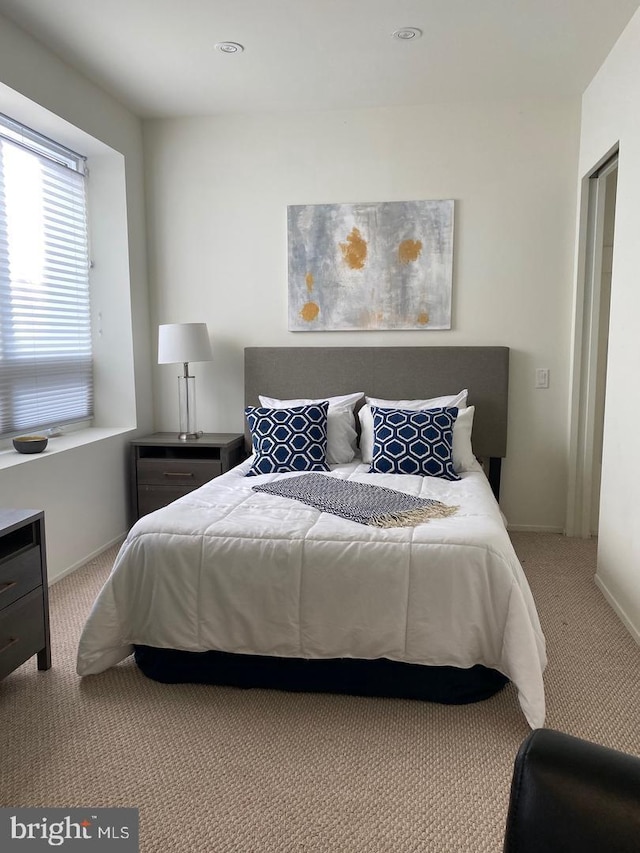 carpeted bedroom featuring baseboards