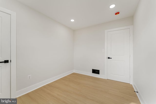 spare room with wood-type flooring