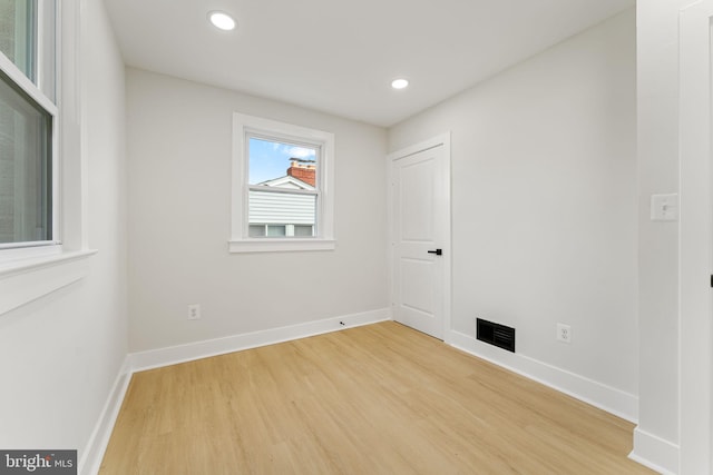 unfurnished room with wood-type flooring