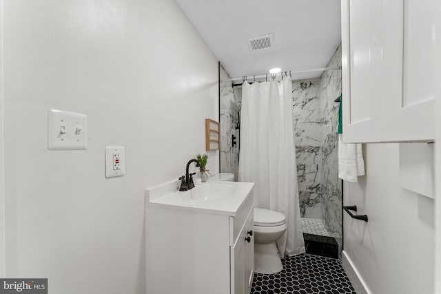 bathroom with a shower with shower curtain, tile patterned flooring, toilet, and vanity