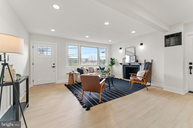 interior space featuring light wood-type flooring and a brick fireplace