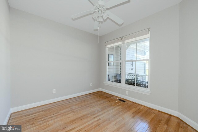 kitchen with crown molding, a kitchen island, light wood-type flooring, plenty of natural light, and white appliances