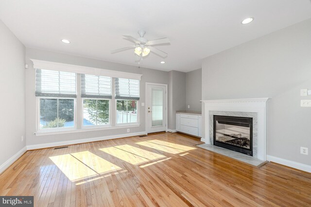 unfurnished dining area featuring ceiling fan, wood finished floors, baseboards, and ornamental molding