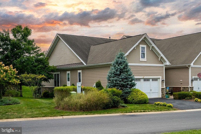 view of front of home with aphalt driveway, a front yard, a garage, and roof with shingles