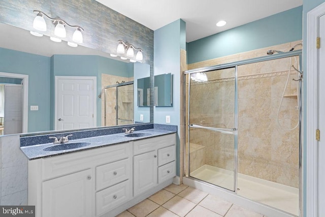 bathroom featuring walk in shower, vanity, and tile patterned floors