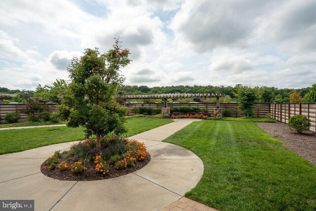 pool with a lawn, a patio, and fence