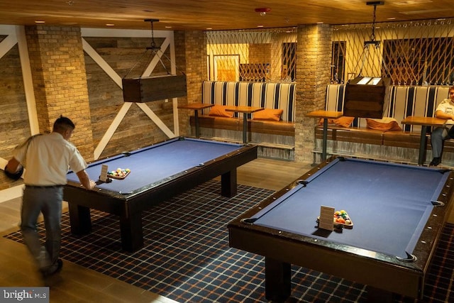 game room with billiards, wood ceiling, and brick wall