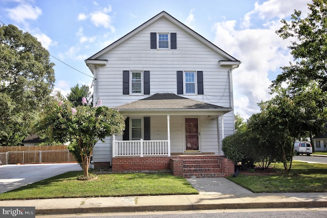 view of property with a front lawn and covered porch