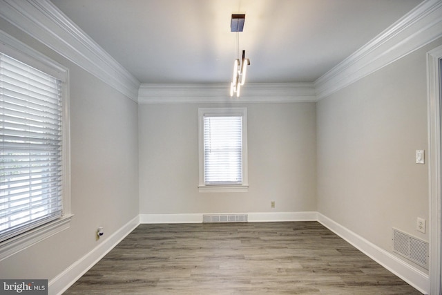 spare room featuring crown molding and hardwood / wood-style floors