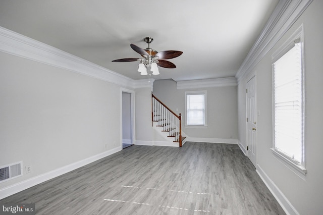 unfurnished living room featuring crown molding, ceiling fan, and light wood-type flooring